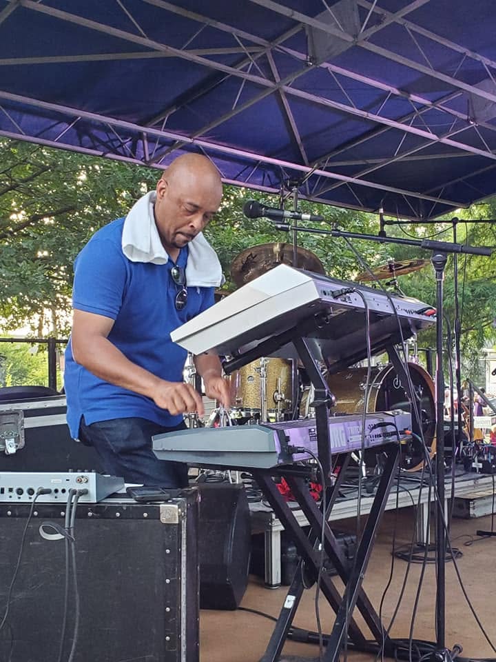 A keyboardist performing on the festival stage.